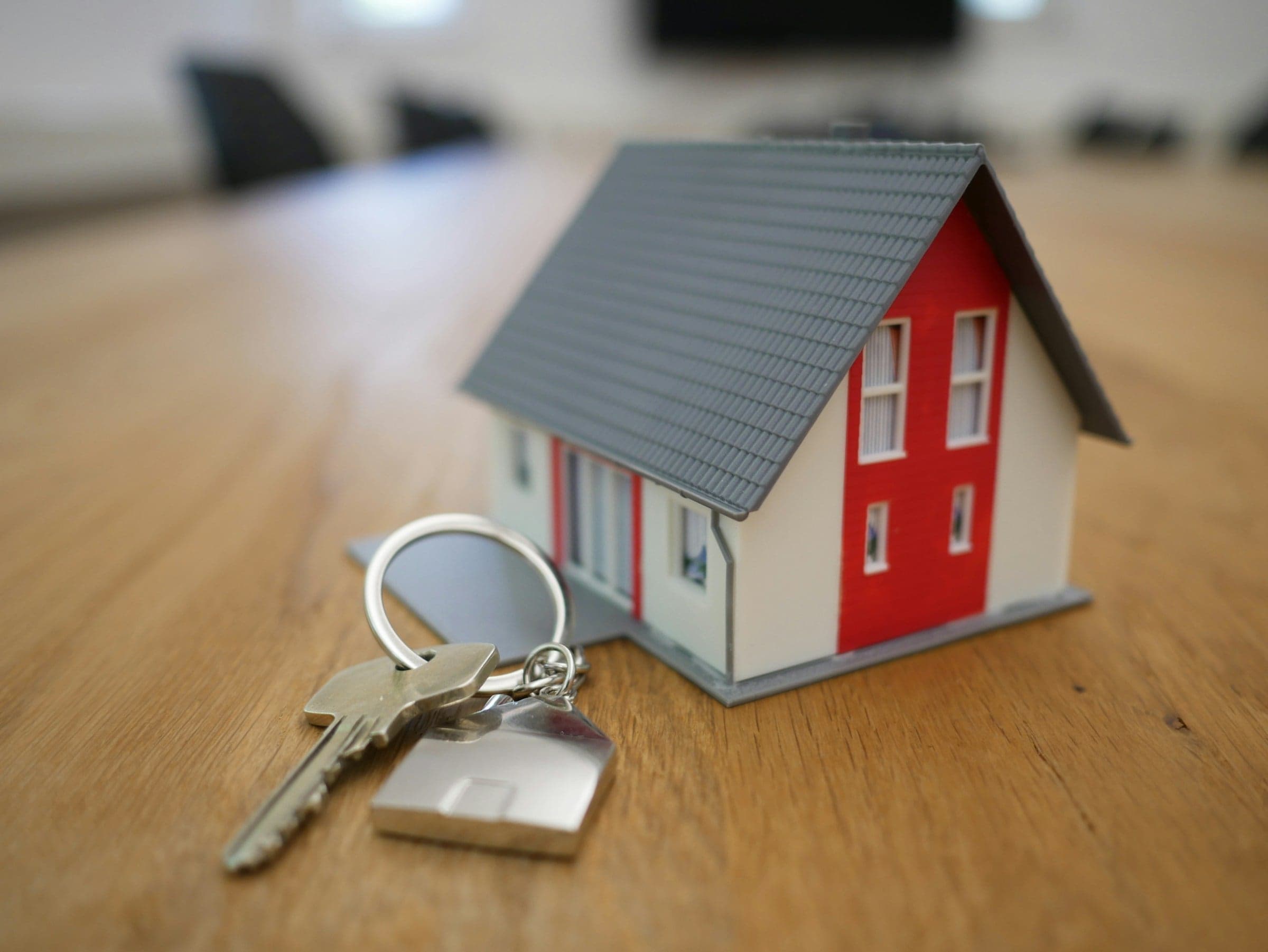 Property manager handing keys and a sealed disclosure packet to a new tenant.